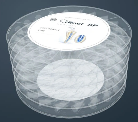 Full stack of five clear trays containing 100 disposable tips with the circular illustrated iRoot SP label, tightly framed on a neutral blue-grey background